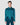 A model wearing a teal satin shirt with a fringed scarf neck and a crystal pin, paired with matching trousers.